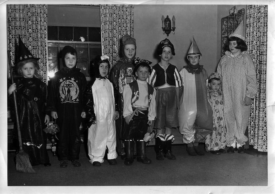 Group of people wearing classic 1950s Halloween costumes